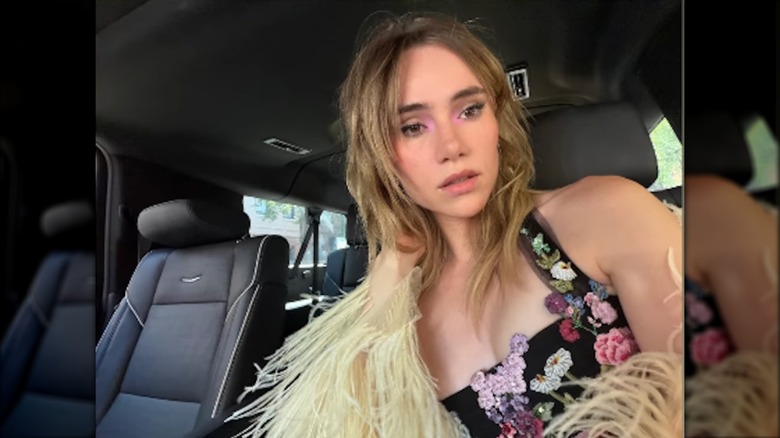 Suki Waterhouse posing in the car on the way to Taylor Swift's wedding reception in an Instagram story