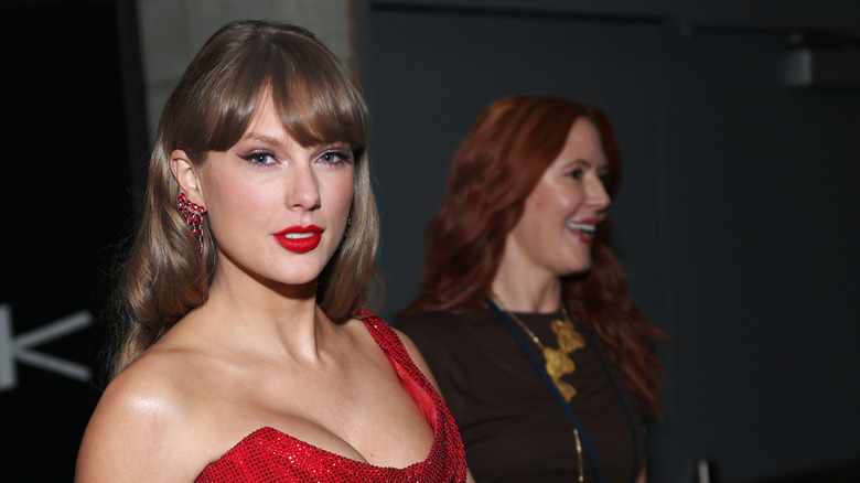 Taylor Swift and Tree Paine posing at an event together.