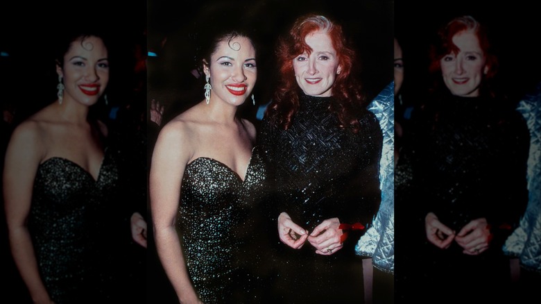 Selena smiling with Bonnie Raitt while wearing a sparkly black gown at the EMI records Post-Grammy Party