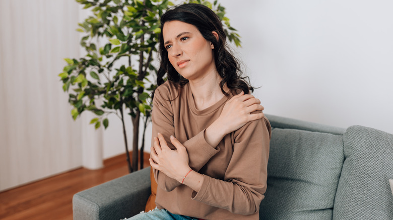 Woman wearing uncomfortable sweater