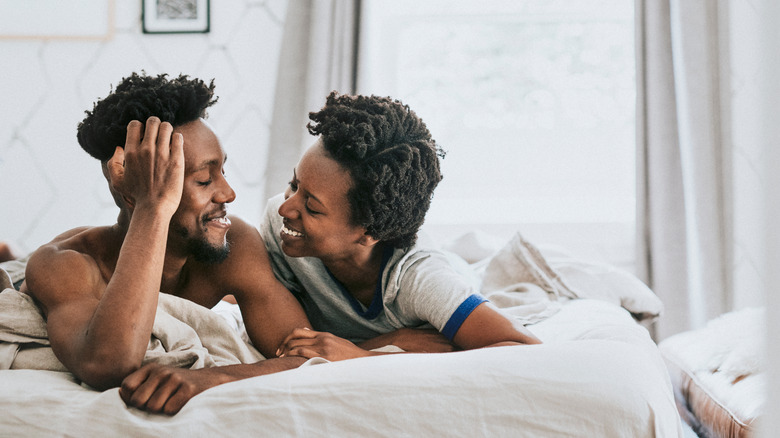 Couple smiling in bed