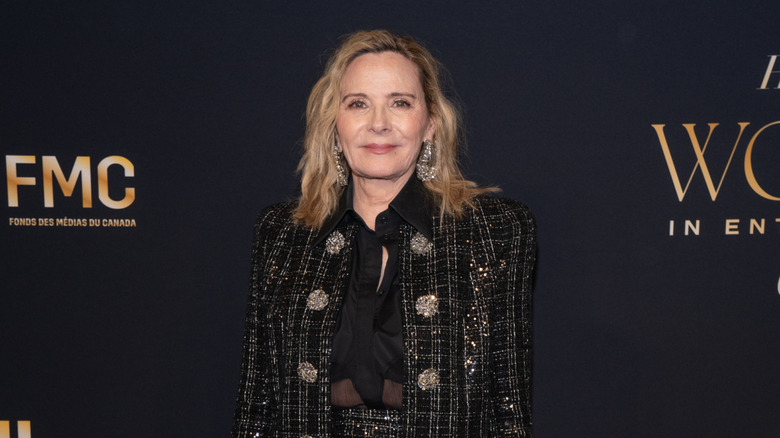 Kim Cattrall on the red carpet in a black tweed suit