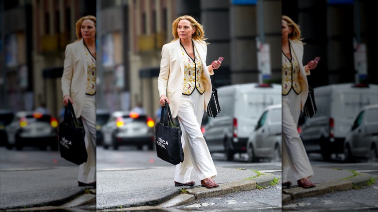 Kim Cattrall wearing an all-white outfit with a cream vest