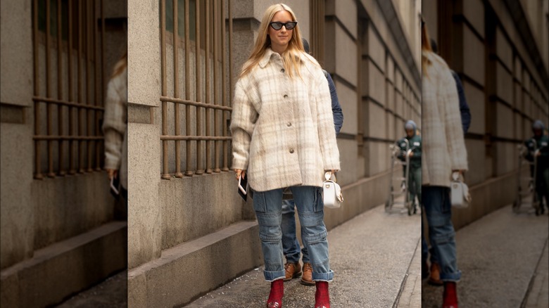 A woman in a cream colored shacket 