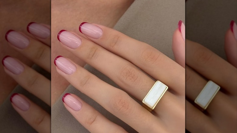 Micro french tip nails with red accent color
