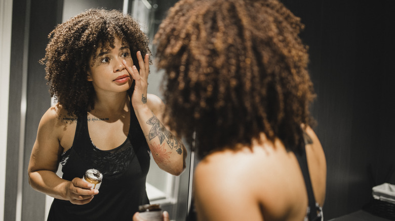 Woman applying skincare