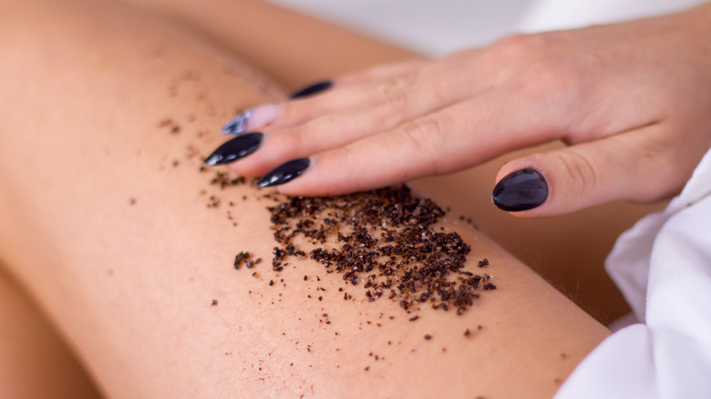 Woman applying a coffee scrub