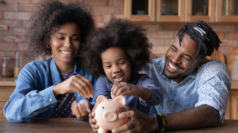 Family putting money in bank