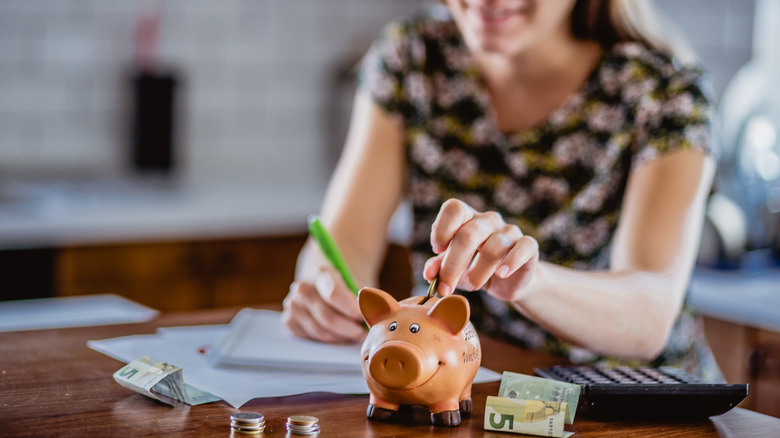 Woman happily saving money