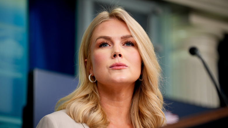 A close up of Karoline Leavitt's face with her looking off in the distance