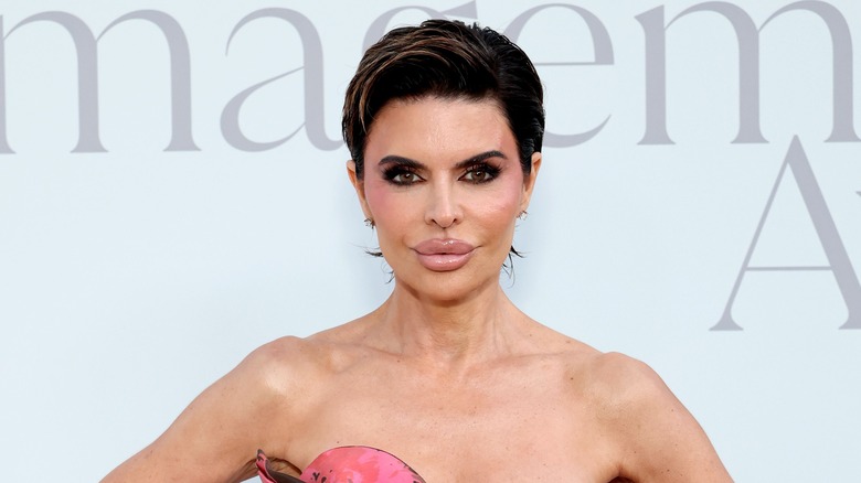 Lisa Rinna posing in a strapless pink dress at an event