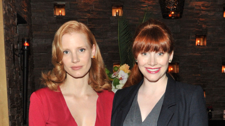 Bryce Dallas Howard and Jessica Chastain standing together in front of a building