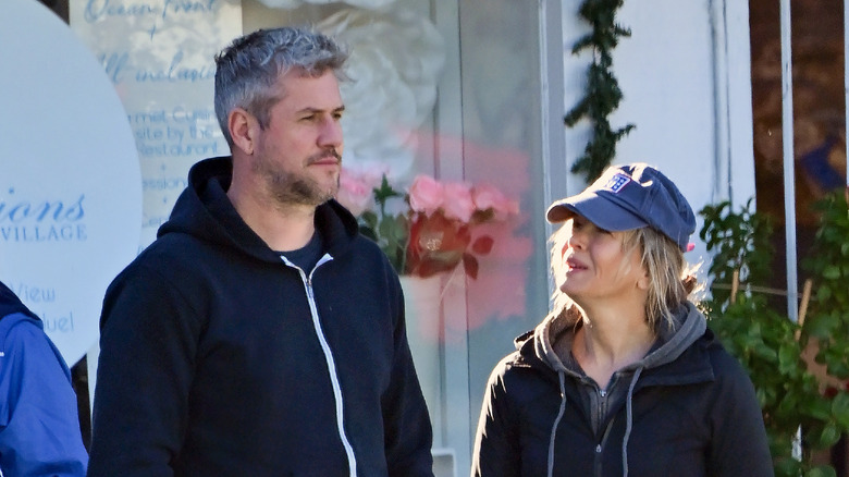 Renée Zellweger and Ant Anstead outside in hoodies