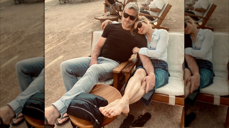 Ant Anstead and Renee Zellweger sitting on chairs on the beach