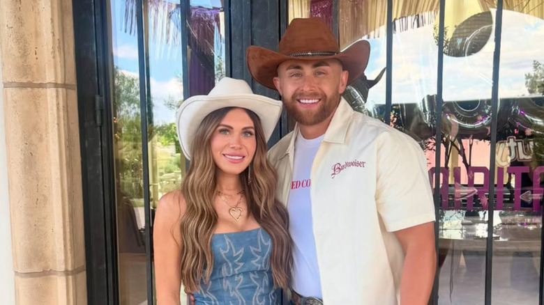 Jessi Draper and Jordan Ngatikaura smile wearing cowboy hats