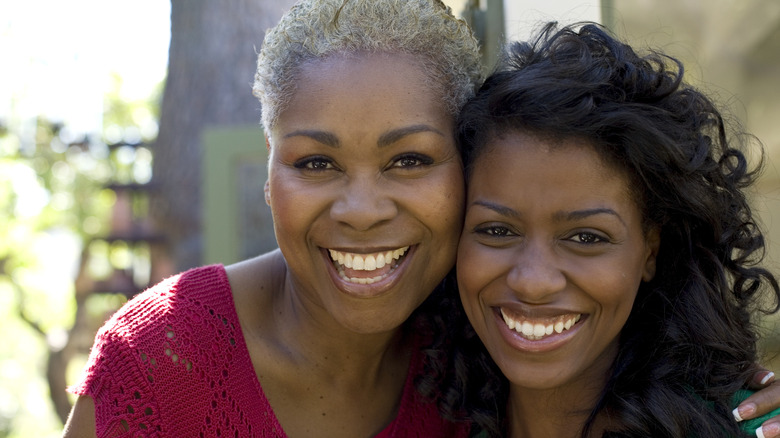 Two women smiling together. 
