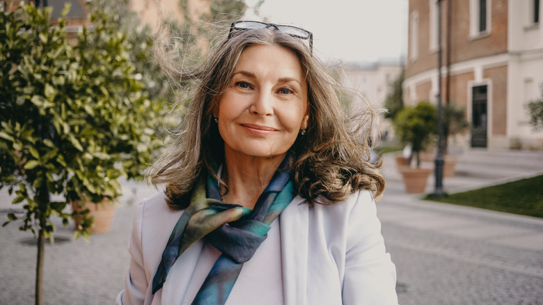 A woman smiling outdoors. 