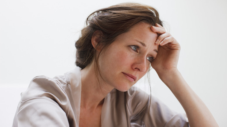 woman hand to forehead