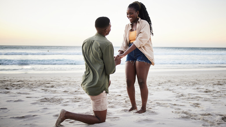man proposing on beach