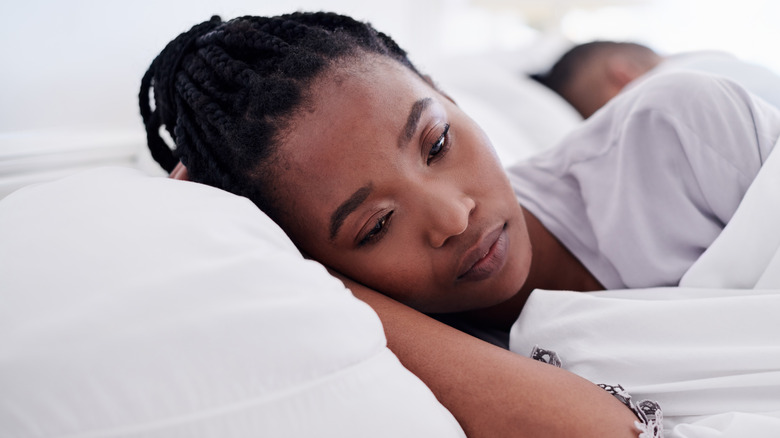 woman sad in bed