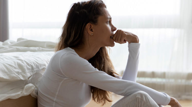 concerned woman sitting on floor