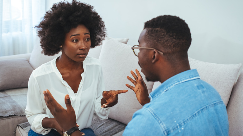 couple having argument on couch