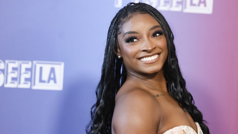 Simone Biles smiling on the red carpet