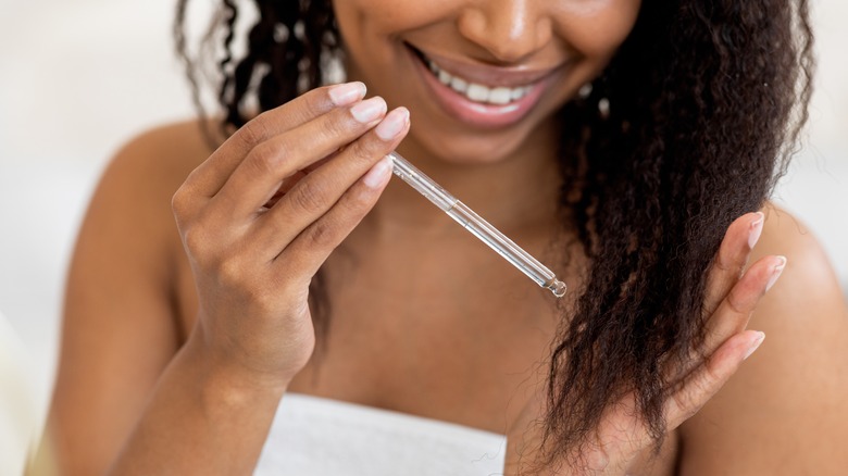 woman applying coconut oil to hair