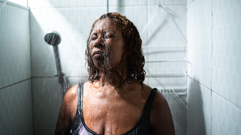 A woman rinsing her hair