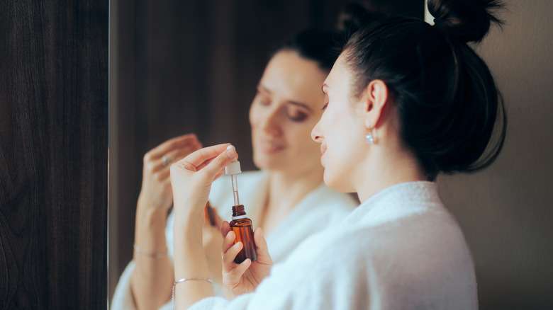 Woman with a skincare bottle