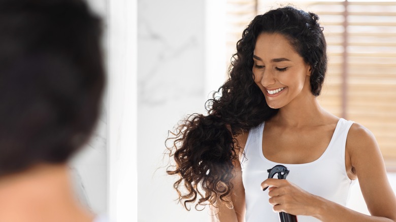 woman using hairspray