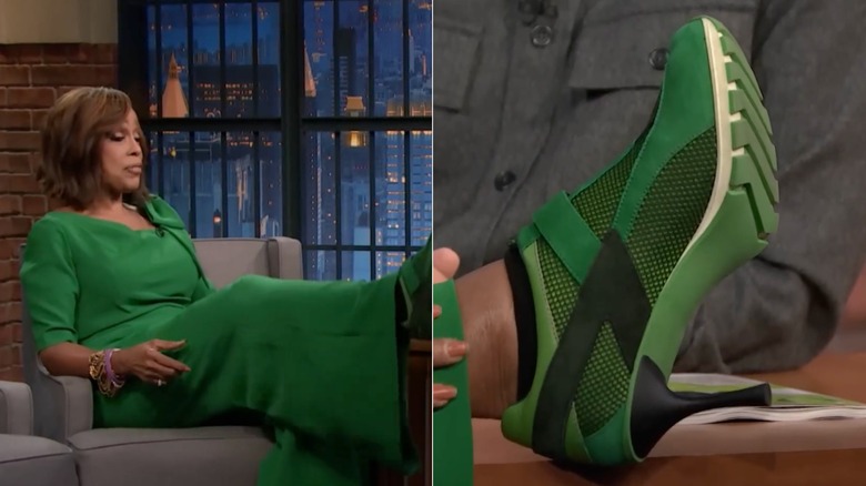 Gayle King puts her feet on a desk wearing a green ensemble