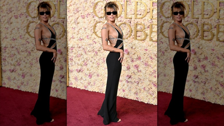 Miley Cyrus on the red carpet in a low cut black gown