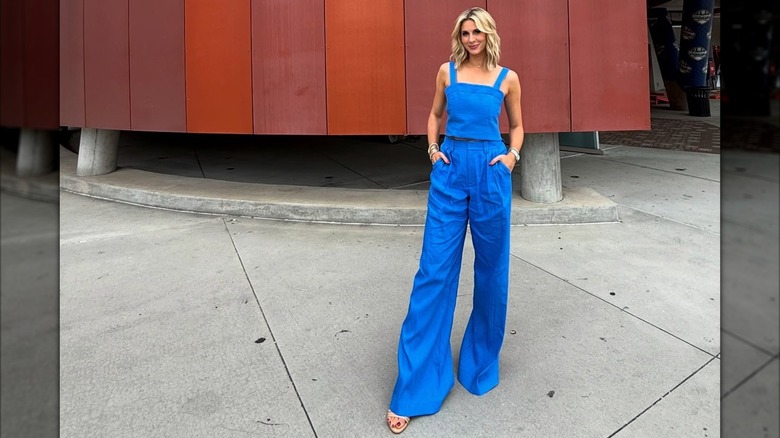 Laura Rutledge in an all blue outfit with wrinkles pants