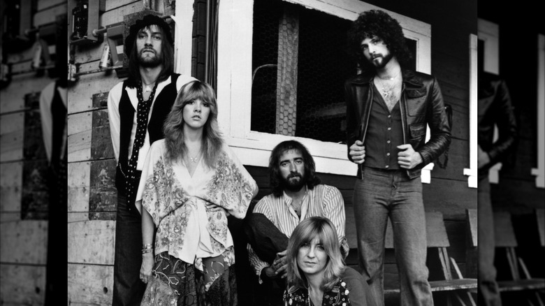 A black-and-white photo showing Stevie Nicks with her Fleetwood Mac bandmates in 1975