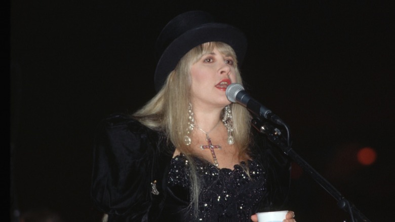 Stevie Nicks performing on stage in 1994 in an all-black outfit
