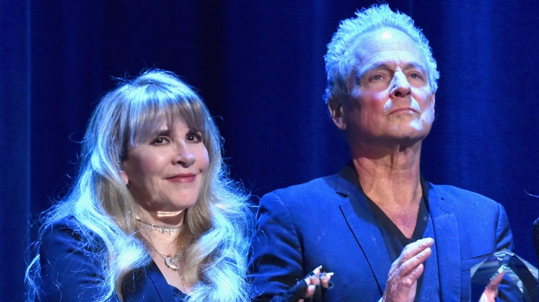Stevie Nicks and Lindsey Buckingham standing side by side at a MusiCares event in 2018