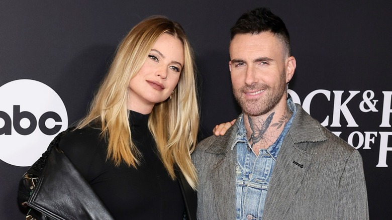 Behati Prinsloo and Adam Levine on a red carpet