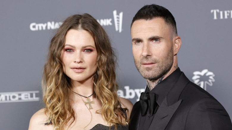 Behati Prinsloo and Adam Levine on a red carpet