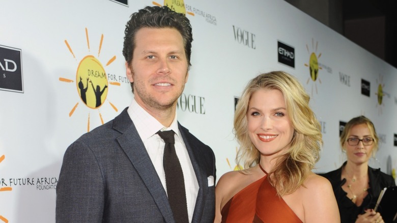 Hayes MacArthur and Ali Larter smiling together on the red carpet
