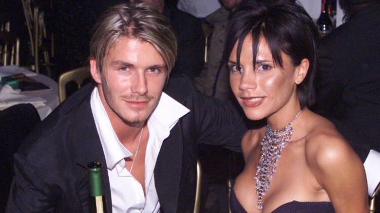 David Beckham and Victoria Beckham sitting at a table together