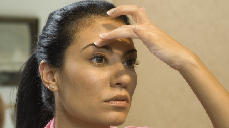 Woman grooming eyebrows