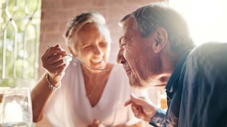 Older woman enjoying dinner with a man