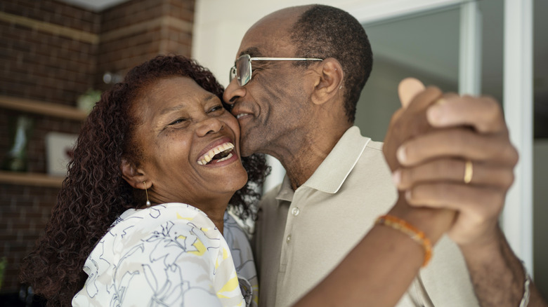 Older couple hugging one another