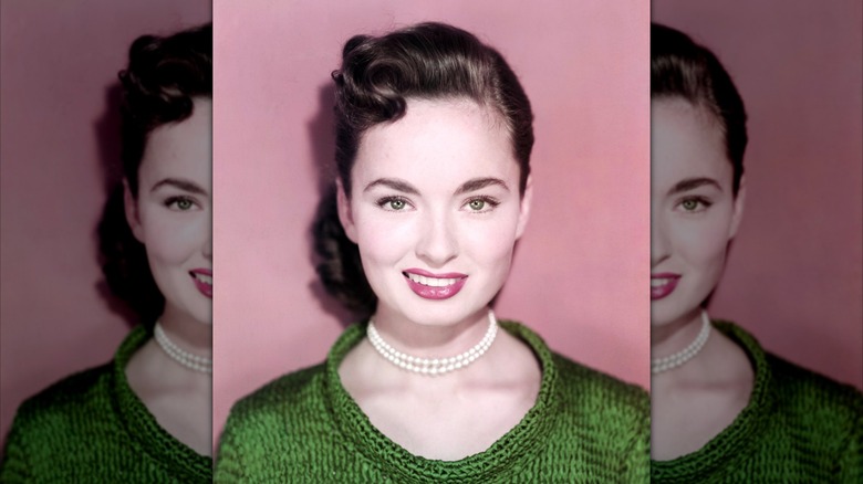 Ann Blyth in pearls and a green sweater in 1950