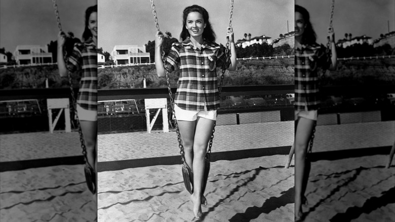 Ann Blyth on a swing set in white shorts in 1949