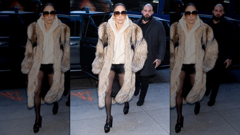 Jennifer Lopez wearing leather-look shorts with a fur-look coat on the streets of New York in 2024