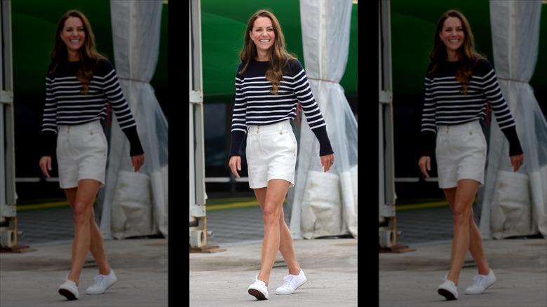Kate Middleton smiling while wearing white shorts and a navy and white striped top