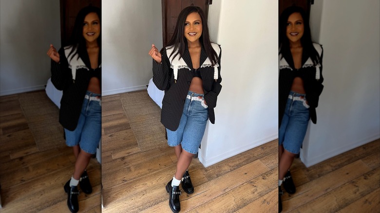 Mindy Kaling wearing denim Bermuda shorts with an open blazer