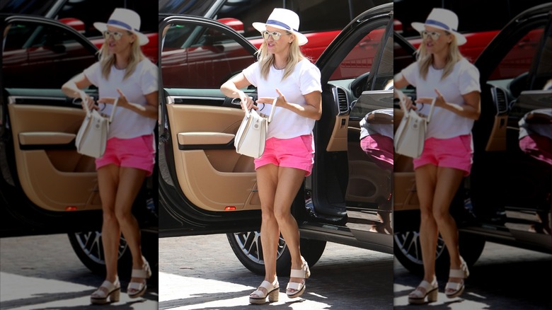 Reese Witherspoon wearing a white t-shirt and pink shorts in 2016
